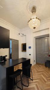 a room with a desk with chairs and a chandelier at The Gediminas Residence in Vilnius