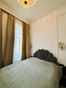 a bedroom with a large bed with a large window at The Gediminas Residence in Vilnius