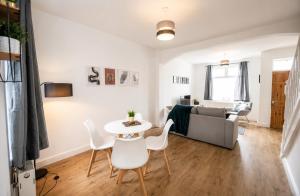 a living room with a couch and a table and chairs at York House - Garston - 3 bedroom - Sleeps 6 in Liverpool +7 photos