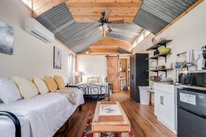 a living room with a white couch and a kitchen at Hill Country Cabin 3 in Canyon Lake