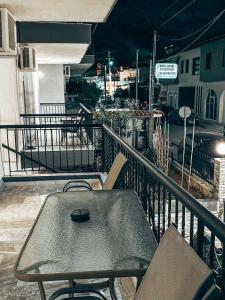 a table and chairs sitting on a balcony at Hotel Galini Polychrono in Polychrono