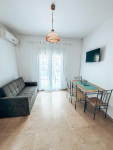 a living room with a couch and a table at Hotel Galini Polychrono in Polychrono