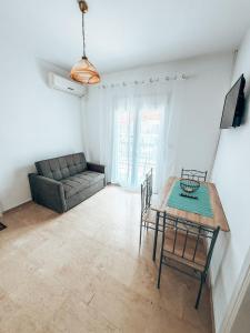 a living room with a table and a couch at Hotel Galini Polychrono in Polychrono