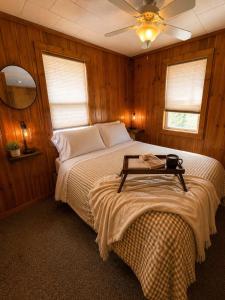 a bedroom with a bed with a table on it at A Shore Thing: Beach Access in Saint Germain