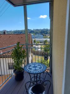 a table and chair on a balcony with a view at Rooms & Apartments Schwäbisch Gmünd in Schwäbisch Gmünd