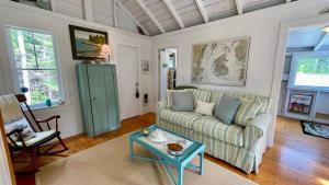 a living room with a couch and a table at Whispering Spruces; Cozy Studio with Queen Bed & W in South Thomaston