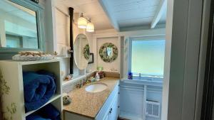 a bathroom with a sink and a mirror at Whispering Spruces; Cozy Studio with Queen Bed & W in South Thomaston +29 photos