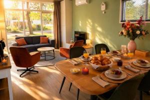 a living room with a table with food on it at Cube & Quiet - Where nature meets comfort in Haarle