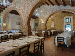a dining room with tables and chairs in a building at Agriturismo Feudo Tudia in Resuttano