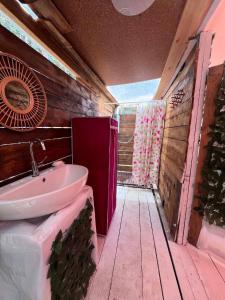 a bathroom with a sink and a wooden wall at Каравана Кукер in Sozopol
