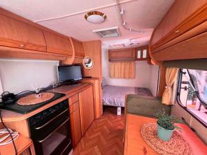 an rv kitchen with a stove and a sink at Каравана Кукер in Sozopol