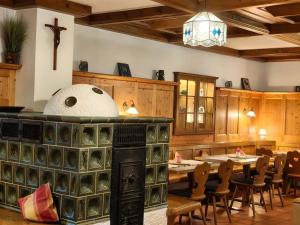 a dining room with tables and chairs and a cross at Frühstück Pension by Anna in Rattenberg