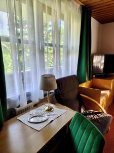 a table with a lamp and glasses on top of it at Frühstück Pension by Anna in Rattenberg