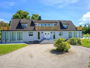 a large white house with a deck on top at 12 person holiday home in BÅSTAD-By Traum in Båstad