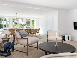 a living room with a table and a dining room at 12 person holiday home in BÅSTAD-By Traum in Båstad