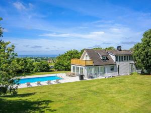 an exterior view of a house with a swimming pool at 12 person holiday home in BÅSTAD-By Traum in Båstad