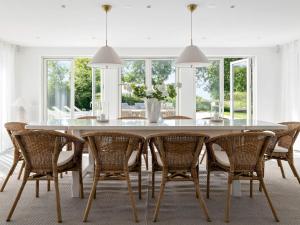 a dining room with a white table and chairs at 12 person holiday home in BÅSTAD-By Traum in Båstad