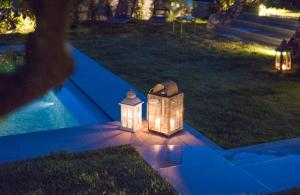 a group of lights sitting on the lawn at night at Romantic Hotel & Restaurant Villa Cheta Elite in Maratea
