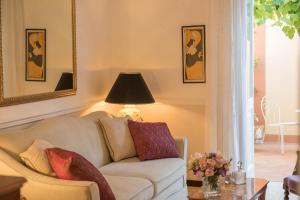 a living room with a white couch and a lamp at Romantic Hotel & Restaurant Villa Cheta Elite in Maratea