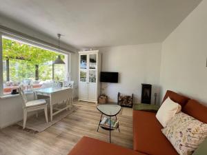 a living room with a couch and a table at Bungalow Louise in Dobbertin in Dobbertin