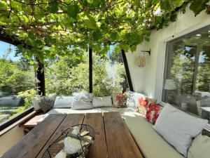 a living room with a wooden table and a large window at Bungalow Louise in Dobbertin in Dobbertin