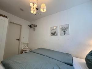 a bedroom with a bed and two pictures on the wall at Bungalow Louise in Dobbertin in Dobbertin