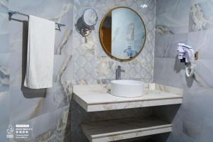 a bathroom with a sink and a mirror at Sabah Resort Nouakchott in Nouakchott