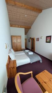 a large bedroom with two beds and a table at La Cascade in Vernayaz