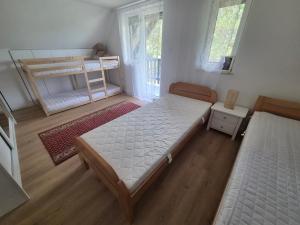 a bedroom with two beds and a crib at Danka Riverside House in Livno