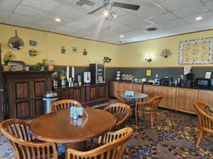 a restaurant with tables and chairs and a counter at The Lodge at Russell - Russell Inn in Russell