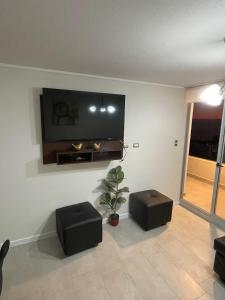 a living room with a flat screen tv on a wall at Comodidad, descanso y disfrute in Algarrobo