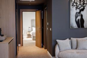 a living room with a couch and a bedroom at Hotel M in Zaton