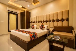 a hotel room with a bed and a couch at Hotel Nayyar Inn Near Golden temple in Amritsar +16 photos