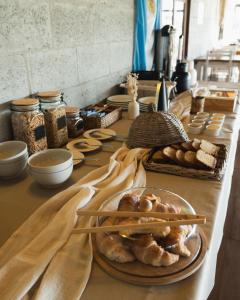 a table topped with plates of pastries and chopsticks at moraycamp in San Andrés de Giles
