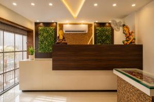 a lobby of a hotel with a large mirror and plants at Hotel Nayyar Inn Near Golden temple in Amritsar