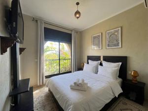 a bedroom with a bed with two towels on it at atlas golf resort in Marrakesh +61 photos