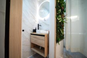 a bathroom with a sink and a mirror at Luxer Holidays in Málaga +24 photos