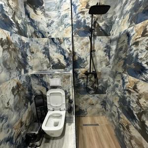 a bathroom with a toilet and a camera in it at Kremelo Hotel in Berat +40 photos