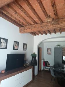 a living room with a flat screen tv on a cabinet at La Corte di Peretola Boutique Apartment in Florence