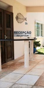 a sign for arecaperecapa reception in front of a building at Panorama Cumbuco in Cumbuco