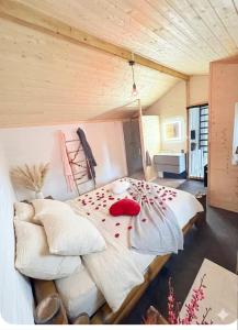 a bedroom with a large bed with roses on it at Cabanoù Lodge & Spa in Messanges