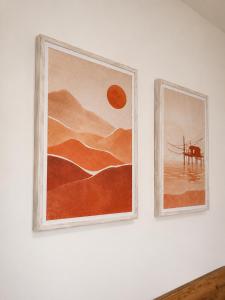 two pictures hanging on a white wall at Orizzonti in Ortona