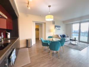 a kitchen and dining room with a table and chairs at Central City Suites with Free Parking in Toronto