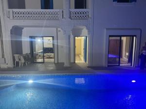 a house with a swimming pool in a room at Djerba Moon in Djerba