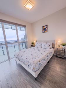 a bedroom with a bed and a large window at Central City Suites with Free Parking in Toronto +33 photos