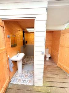 a bathroom with a toilet and a sink at Cabanoù Lodge & Spa in Messanges +11 photos