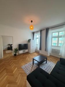 a living room with a couch and a table at Holstentor Apartment in Lübeck