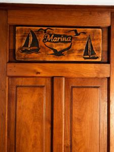 a wooden cabinet with a marina sign on it at Casa Vista Pacífico in Concón