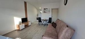 a living room with a couch and a table at JMM Apartment in Kotor