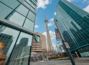 a view of a city with a clock tower and buildings at Central City Suites with Free Parking in Toronto